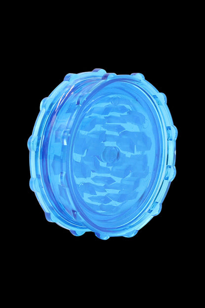 Blue cannabis grinder isolated on a black background.