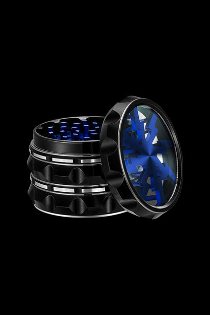 Open black and blue cannabis grinder on a black background.
