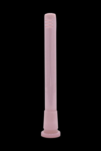 Pink glass pipe for smoking cannabis, isolated on a black background.