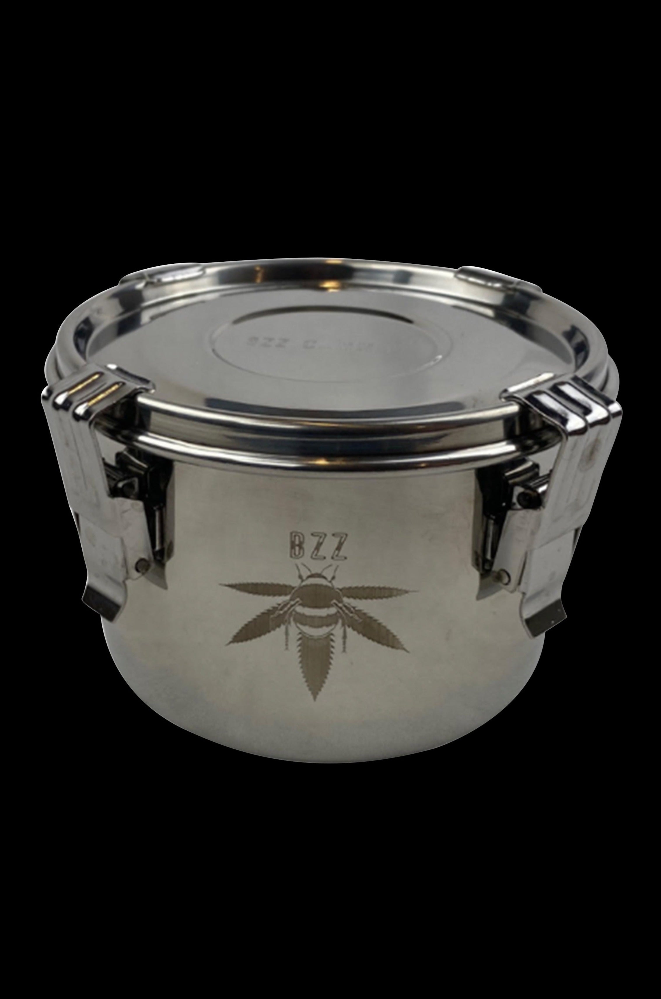 Silver cannabis storage container with a leaf emblem.