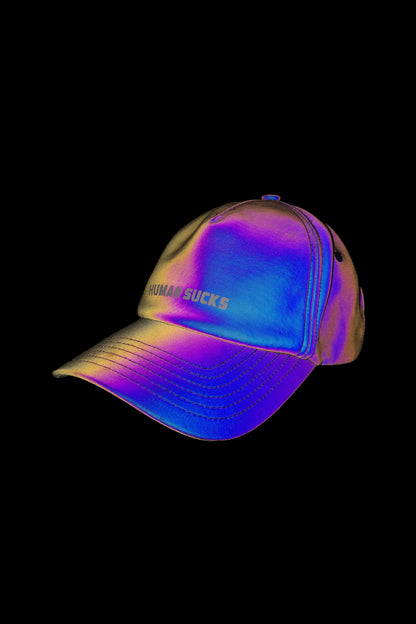 Iridescent cannabis accessory baseball cap with “Humans Sucks” embroidered on the front, isolated on black.