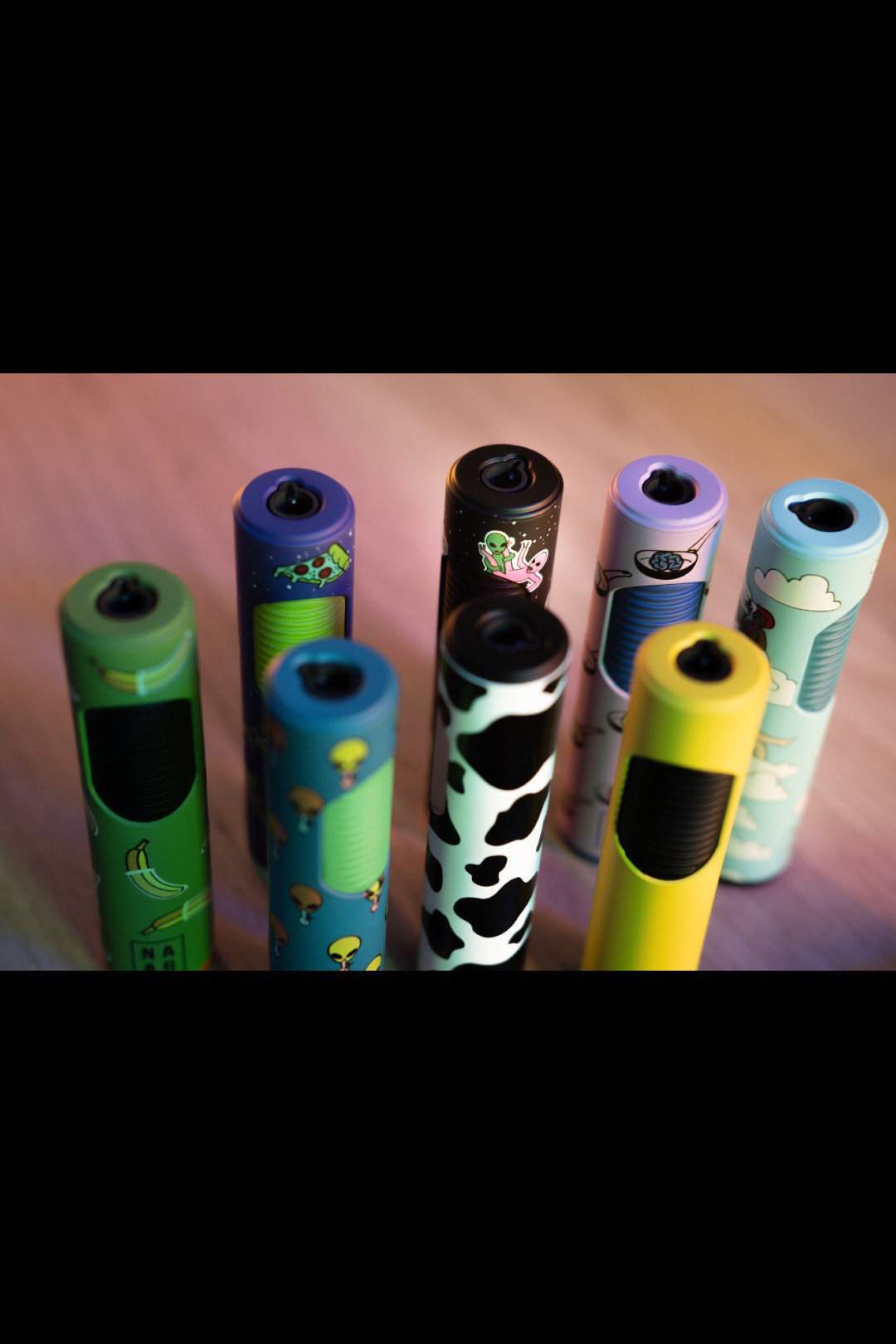 A colorful arrangement of NAAR Jet Lighters, viewed from a slightly angled, close-up perspective against a dark background.