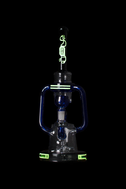 Blue glass water pipe with green accents, studio shot on black background.