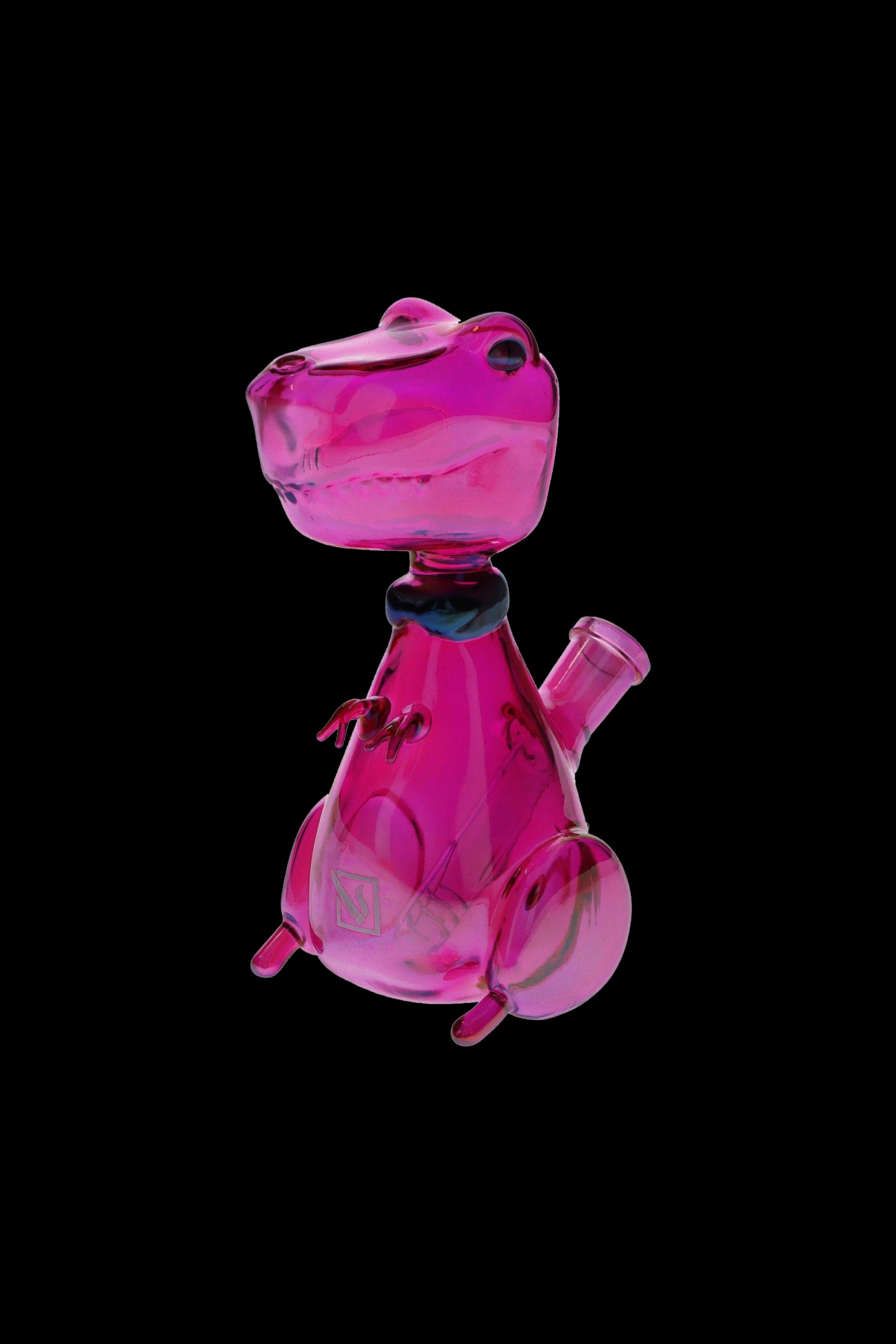 Pink glass dinosaur-shaped bubbler for cannabis smoking, isolated on a black background.