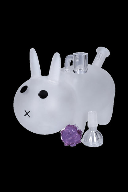 Glass bunny-shaped water pipe with purple cannabis bud and oil dome.