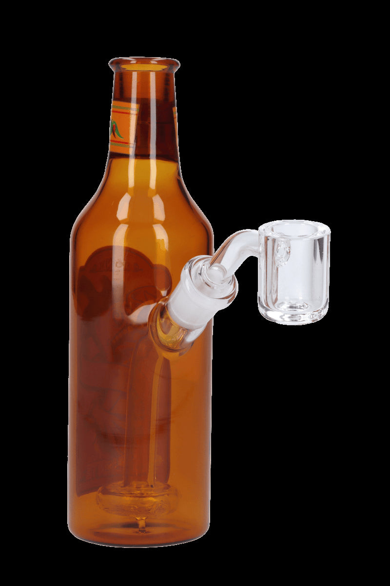 Glass bong shaped like a beer bottle with a quartz banger.