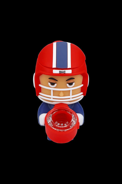 Red football player-shaped silicone smoking pipe with a visible bowl.