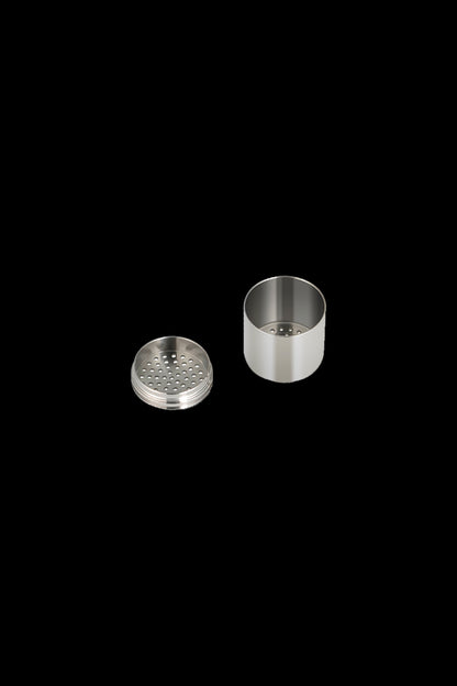 Silver metal grinder components separated, showing a perforated grinding plate and cylindrical base.