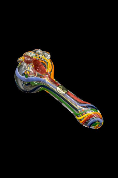 Colorful glass smoking pipe against a black background.