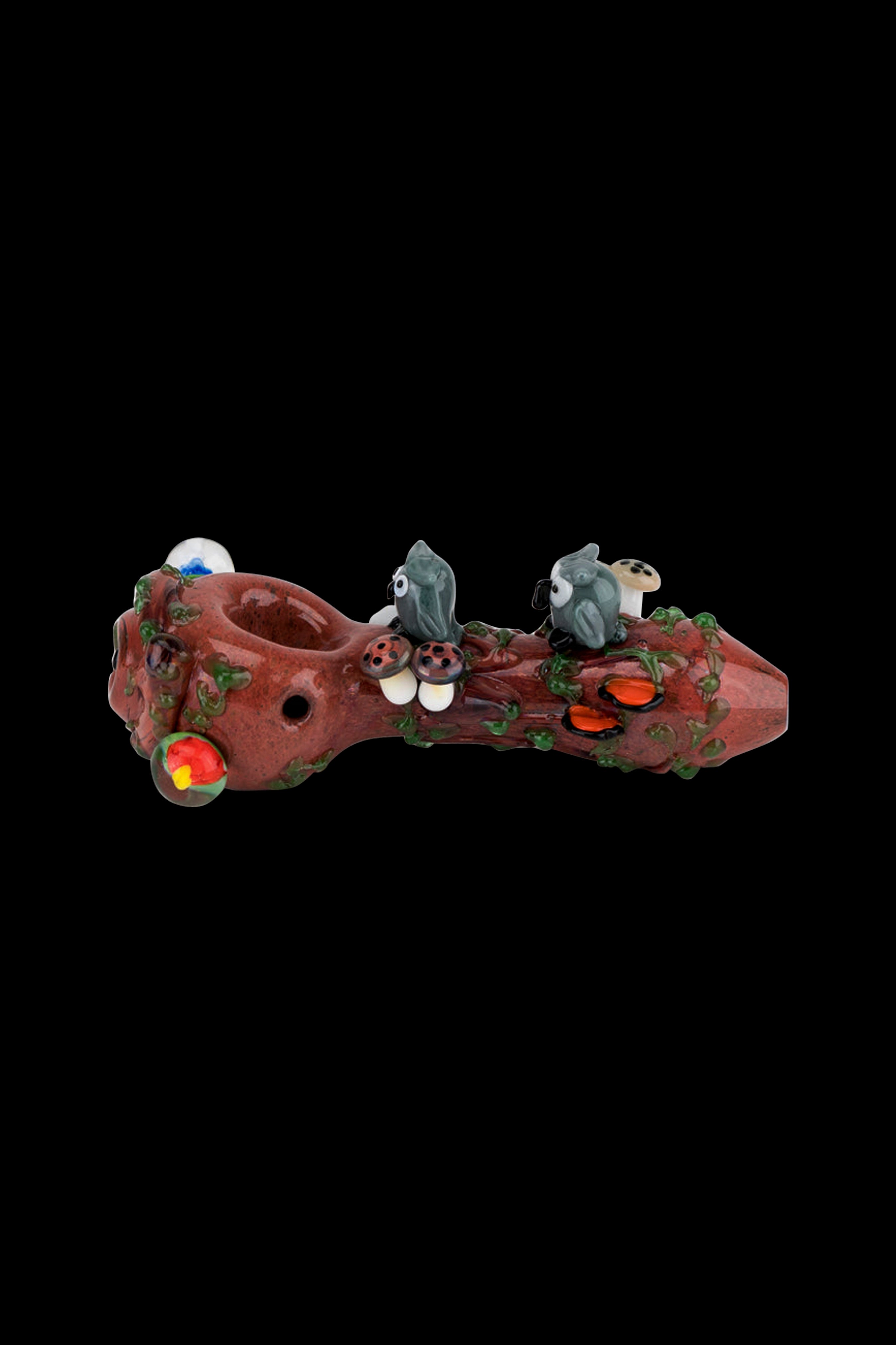 Hand-blown glass pipe shaped like a tree branch with sculpted mushrooms and colorful glass accents, isolated on a black background.