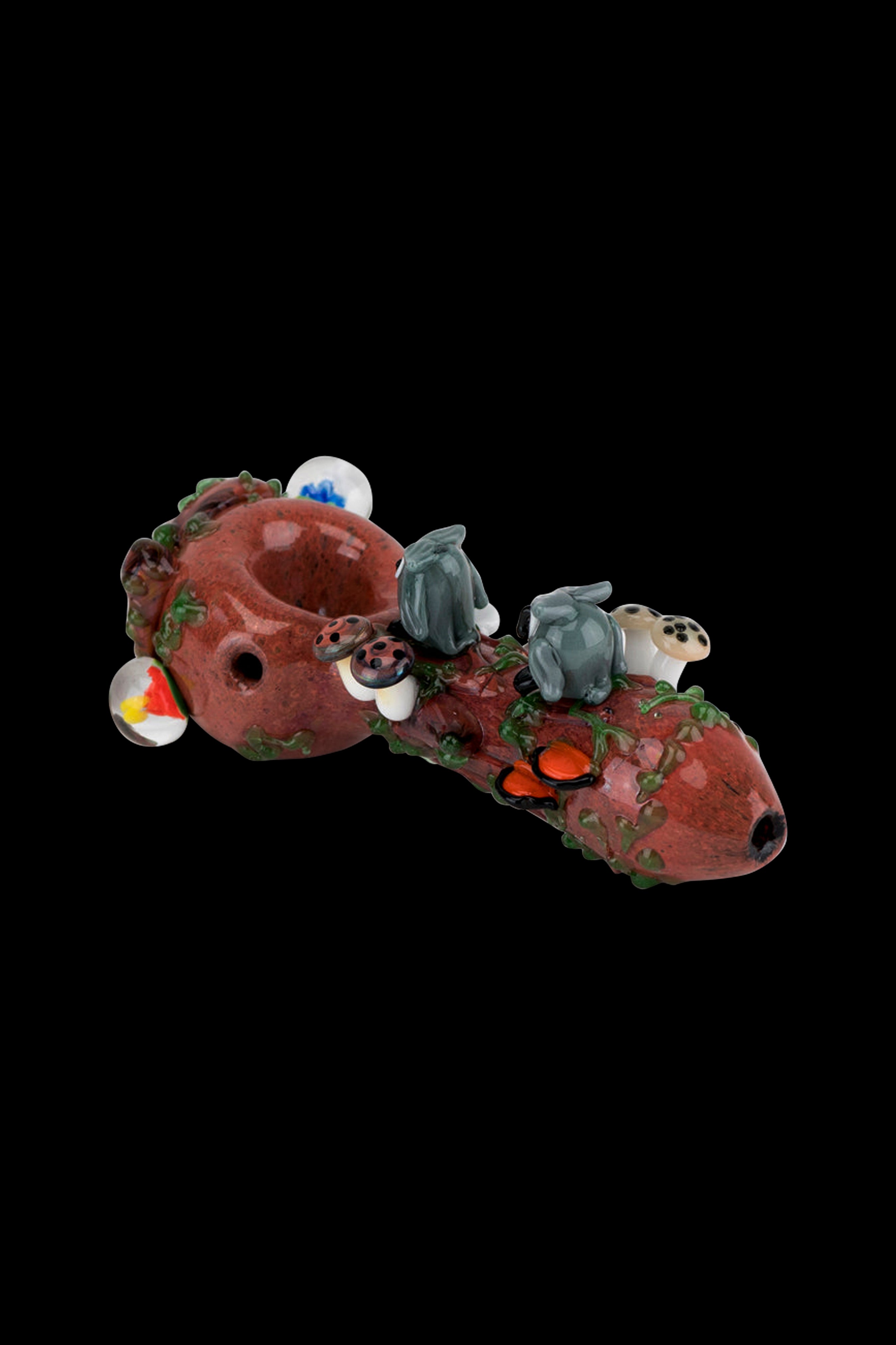Hand-blown glass pipe shaped like a whimsical mushroom with sculpted figures.