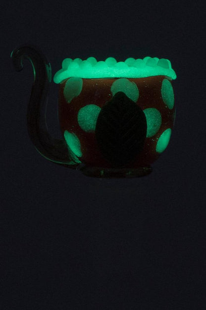 Glow-in-the-dark glass cannabis pipe shaped like a mushroom.