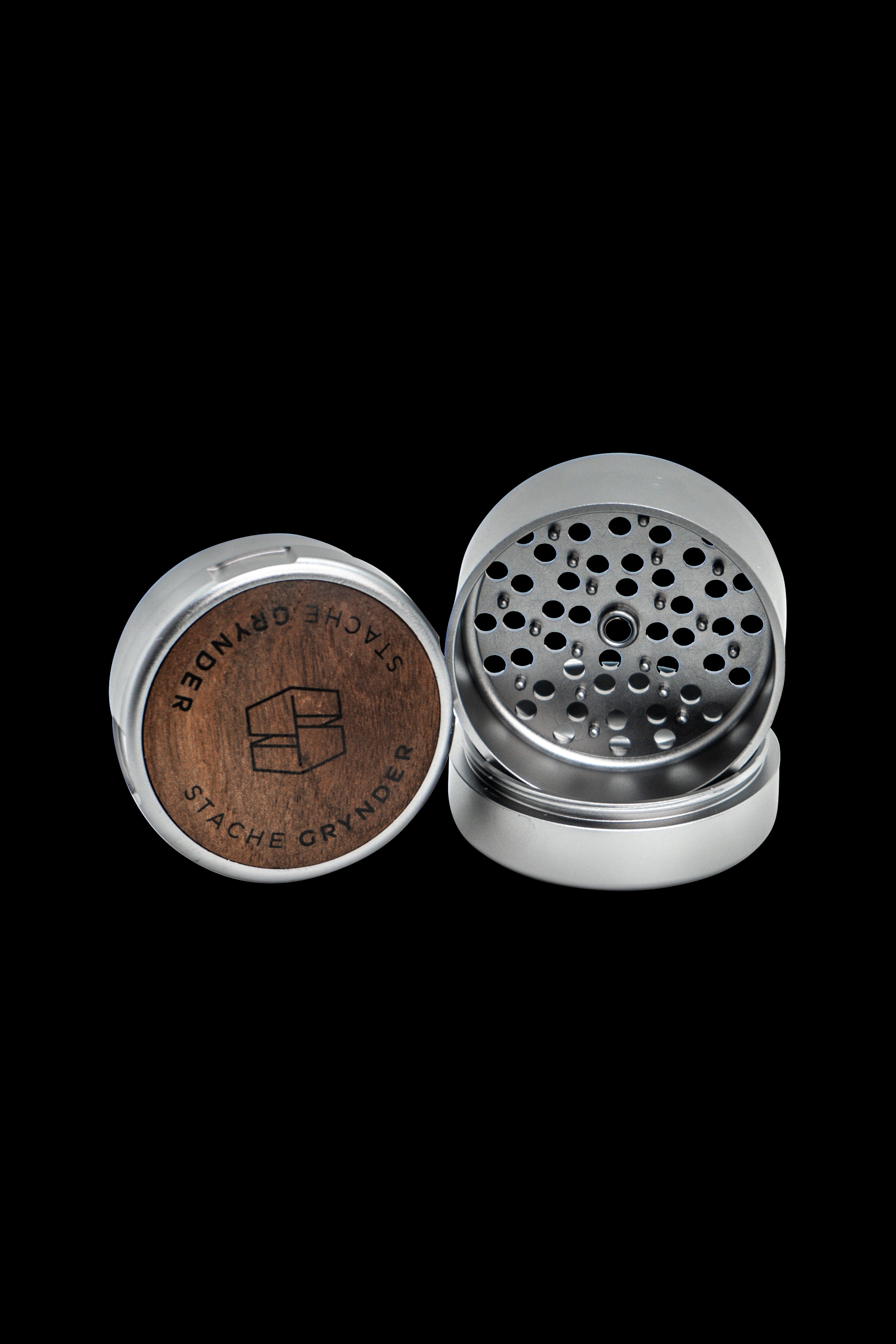 Silver and wood cannabis grinder with lid open, revealing grinding teeth.