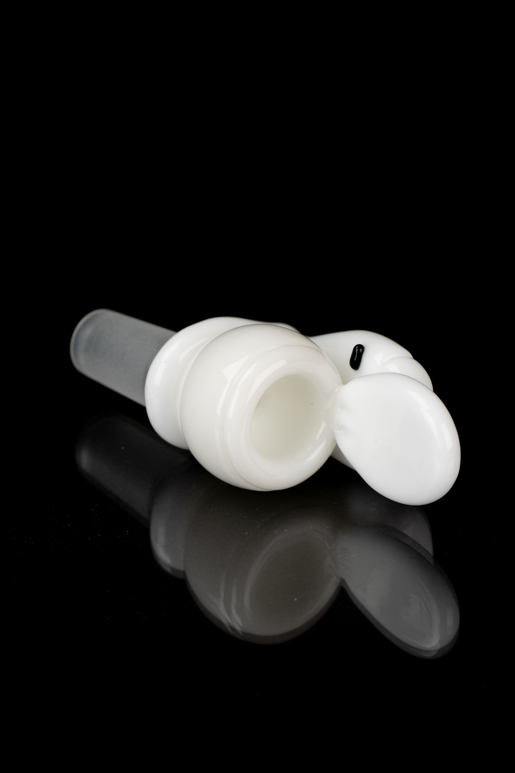 White glass cannabis bubbler with a rounded shape and clear mouthpiece, reflecting on a dark surface.