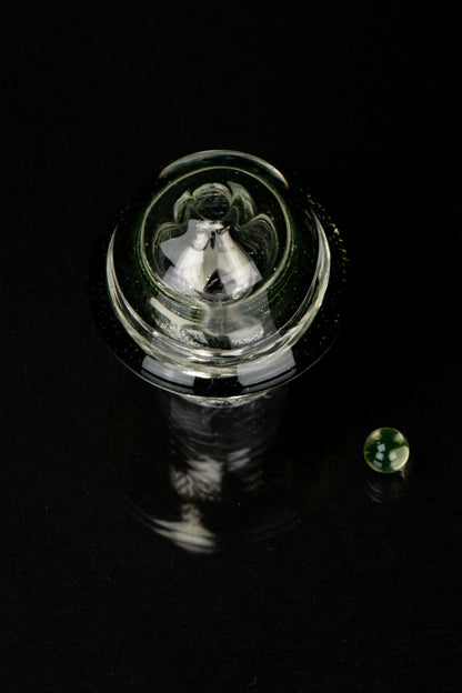 Glass cannabis water pipe against a black background.