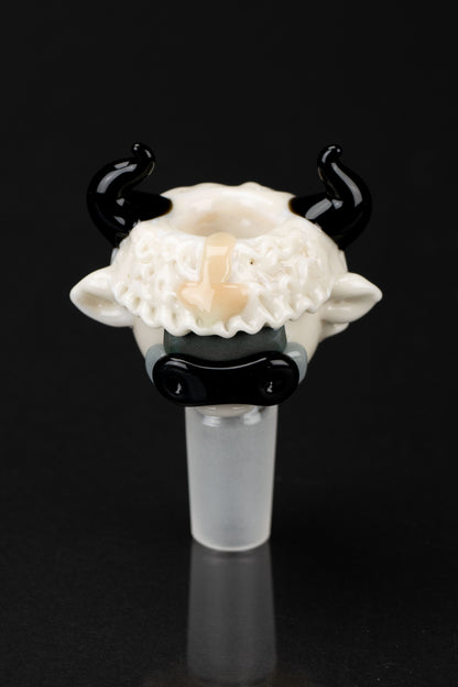 Glass cannabis pipe shaped like a cow's head with black horns, against a black background.