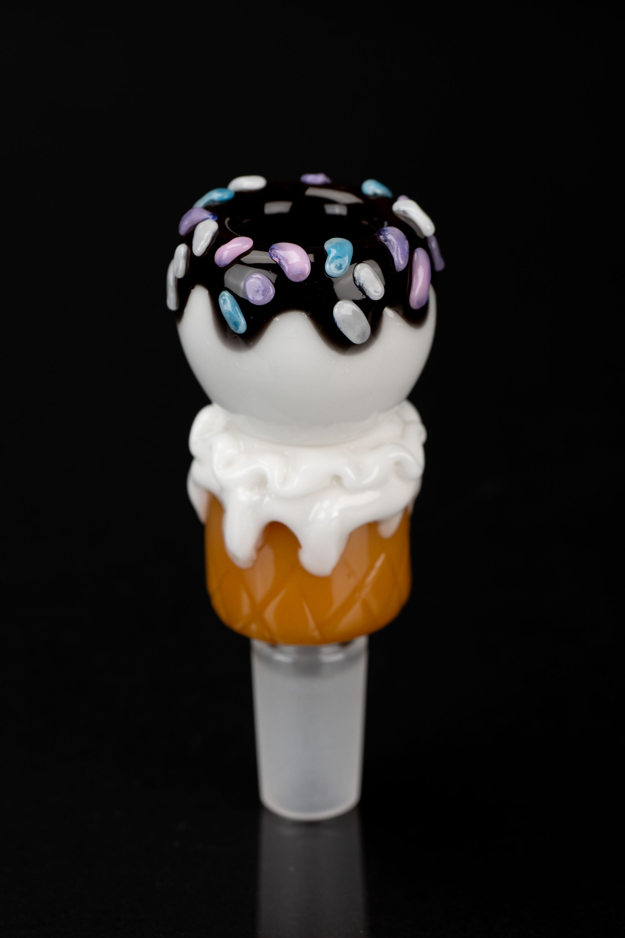 Glass cannabis pipe shaped like a frosted donut with colorful sprinkles, against a black background.