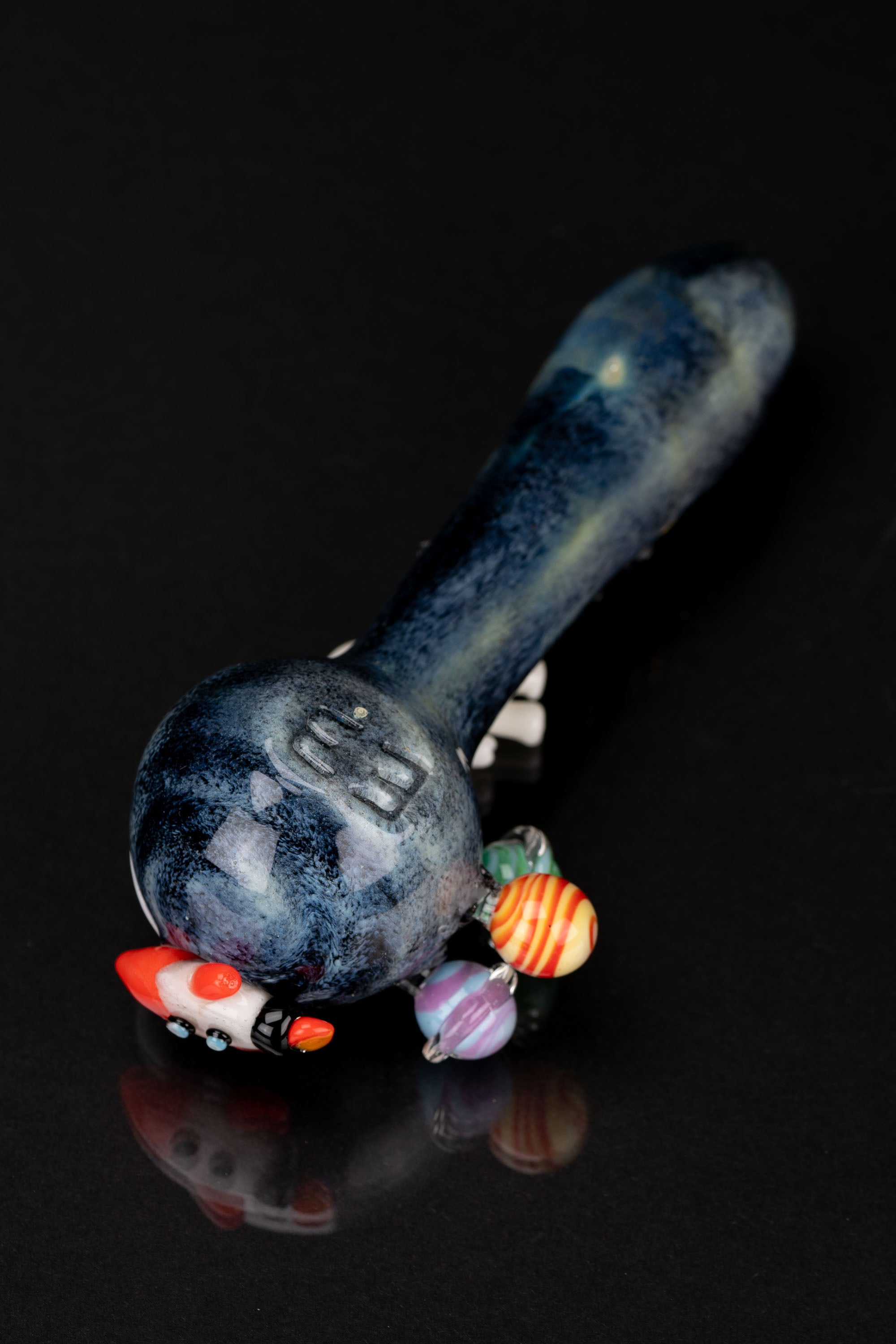 Hand-blown glass pipe with a space theme, featuring planets and a rocket ship design.