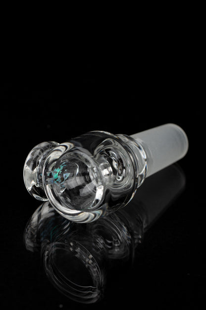 Clear glass cannabis bowl with intricate swirling design, reflecting on a dark surface.