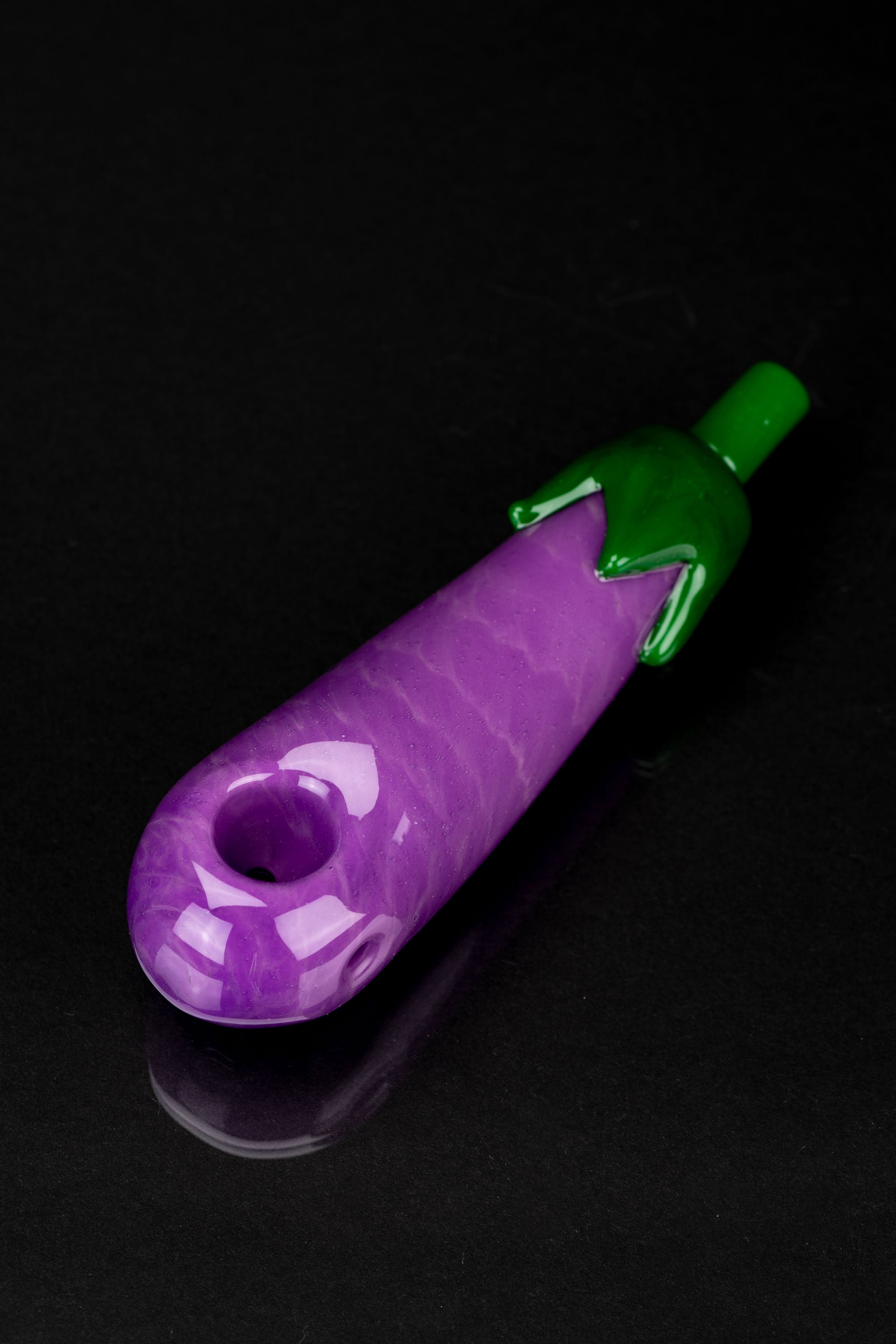 Purple glass pipe shaped like an eggplant.