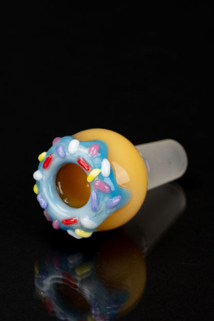 Glass cannabis bowl shaped like a frosted donut with colorful sprinkles.