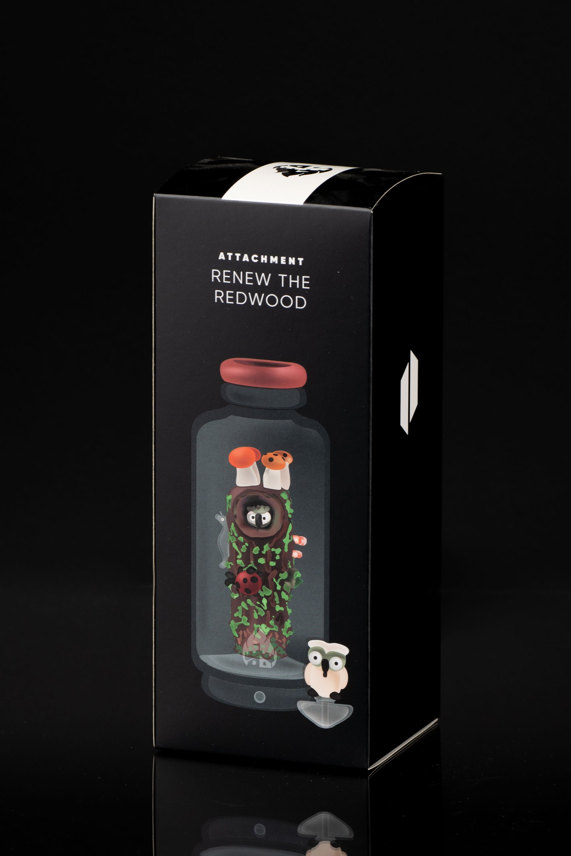 Product packaging for “Attachment Renew the Redwood,” featuring a clear, bulb-shaped vaporizer with botanical illustrations and a cartoon character, against a black backdrop.
