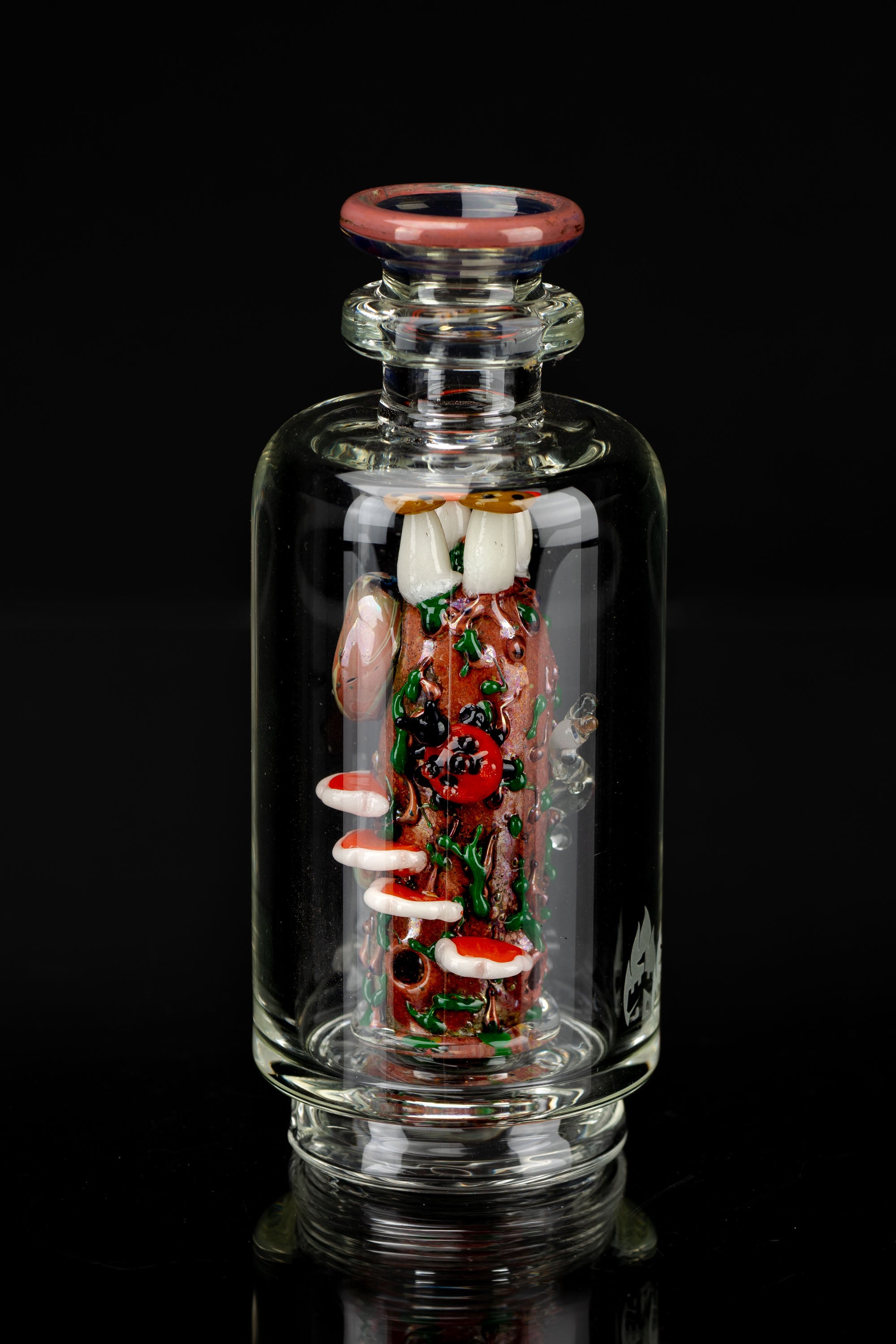 Hand-blown glass cannabis oil rig with intricate red and green detailing.
