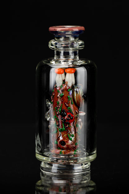 Intricate glass cannabis water pipe featuring a red and green sculpted design resembling a brain, set against a black background.