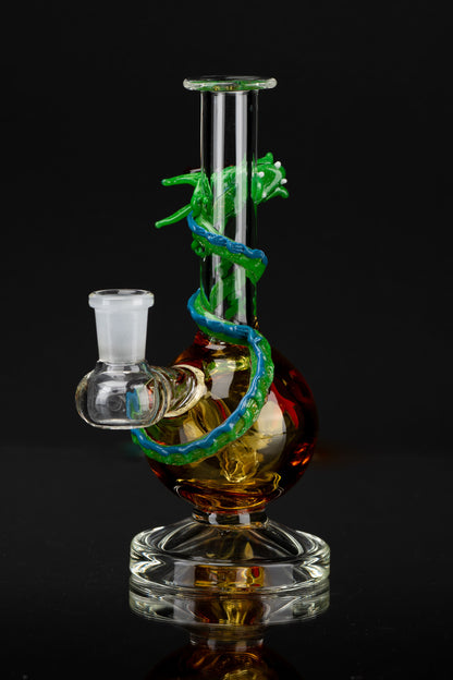 A colorful glass water pipe, also known as a bong, with a serpentine design, set against a black background.