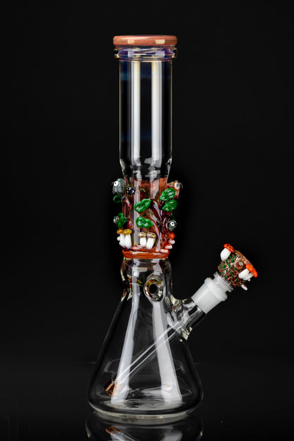 Hand-blown glass water pipe (bong) with colorful sculpted details against a black background.