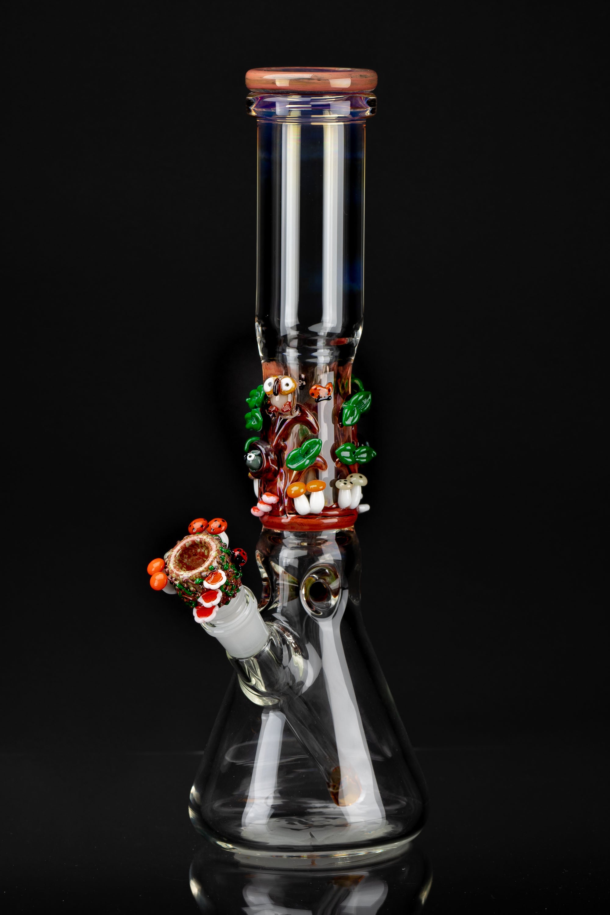 Glass bong with colorful sculpted mushroom and bug details, studio shot on black.