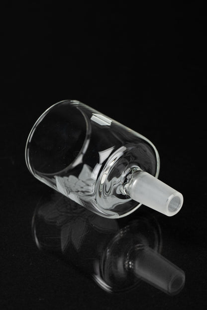 Clear glass bubbler with intricate swirling design, isolated on black.