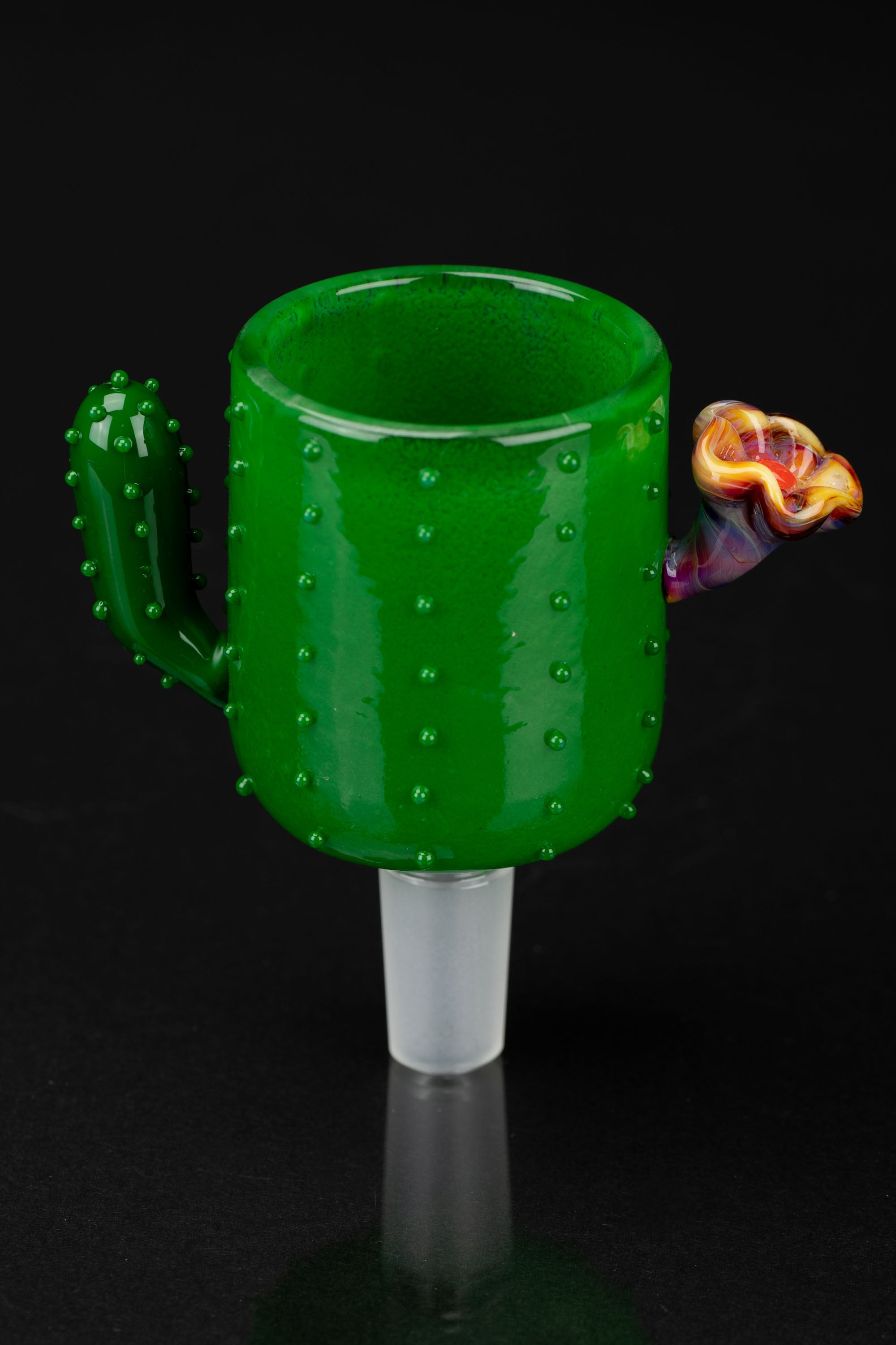 Green glass cactus-shaped smoking piece with a floral accent, studio shot on black.
