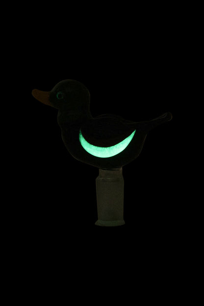 Glowing green duck-shaped glass pipe on a black background.