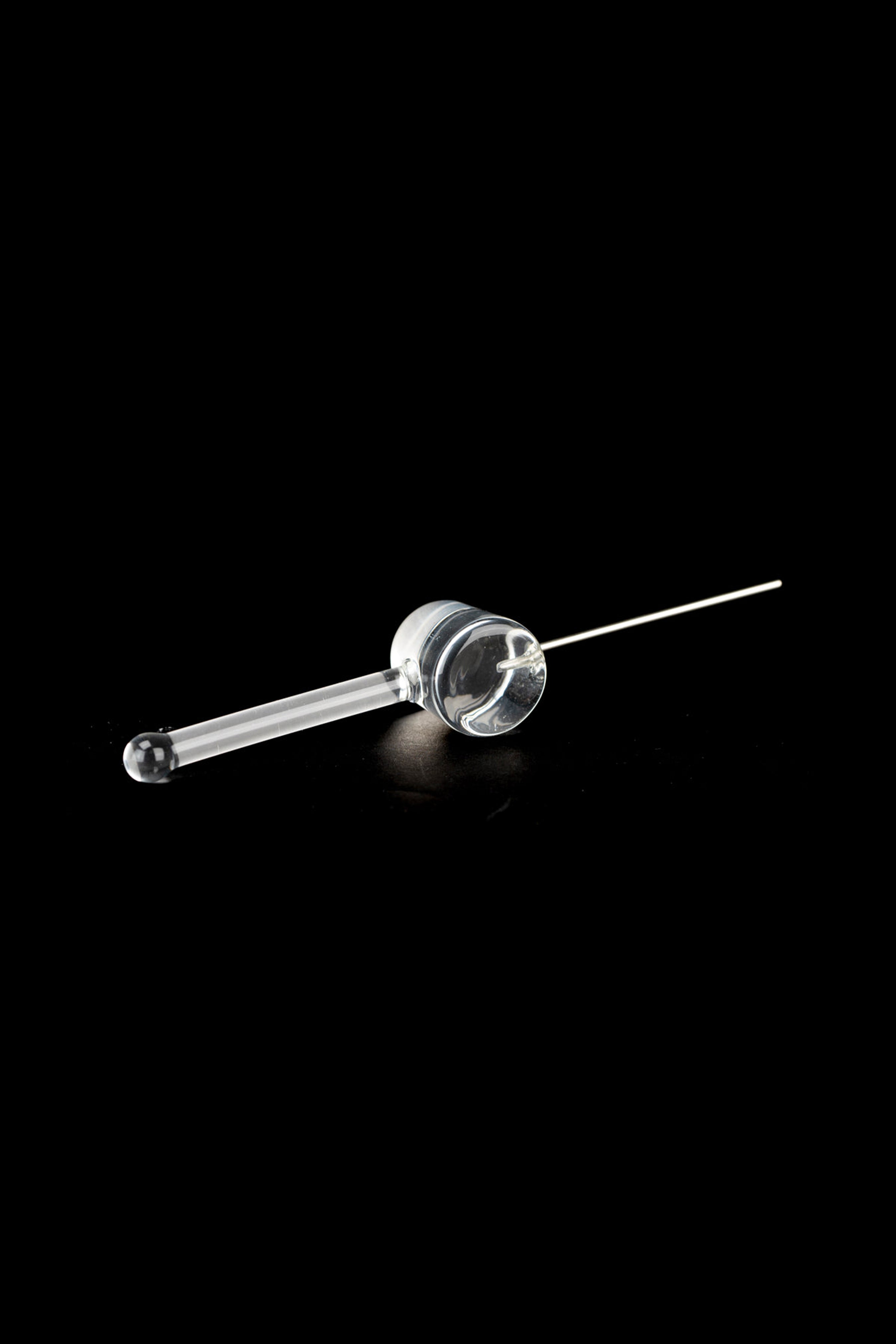 Clear glass oil burner pipe for cannabis concentrates on a black background.