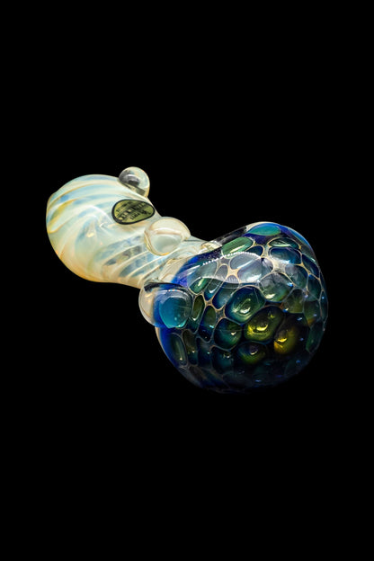 Hand-blown glass pipe with a speckled blue and green bowl, against a black background.