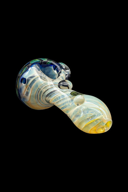 Glass cannabis pipe with swirling blue and yellow patterns on a black background.