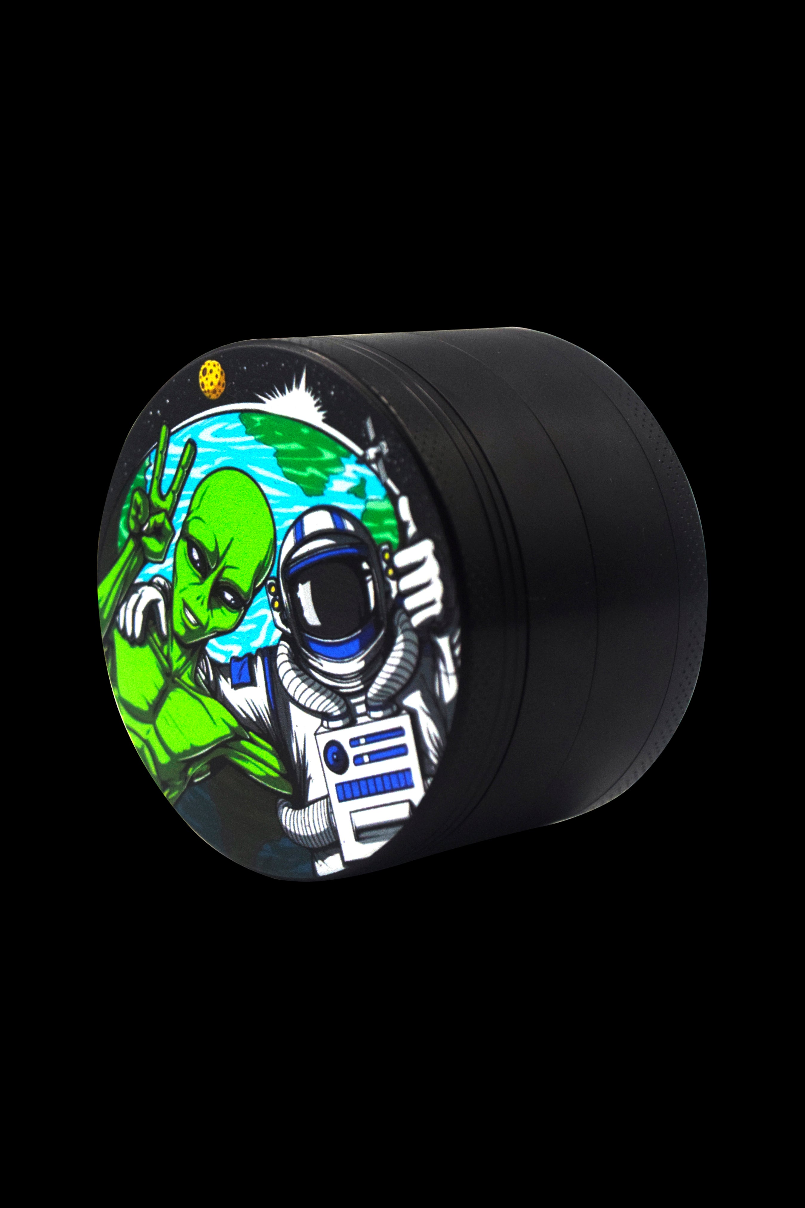 Close-up of a black grinder with a colorful, psychedelic design featuring an astronaut and alien on the lid.
