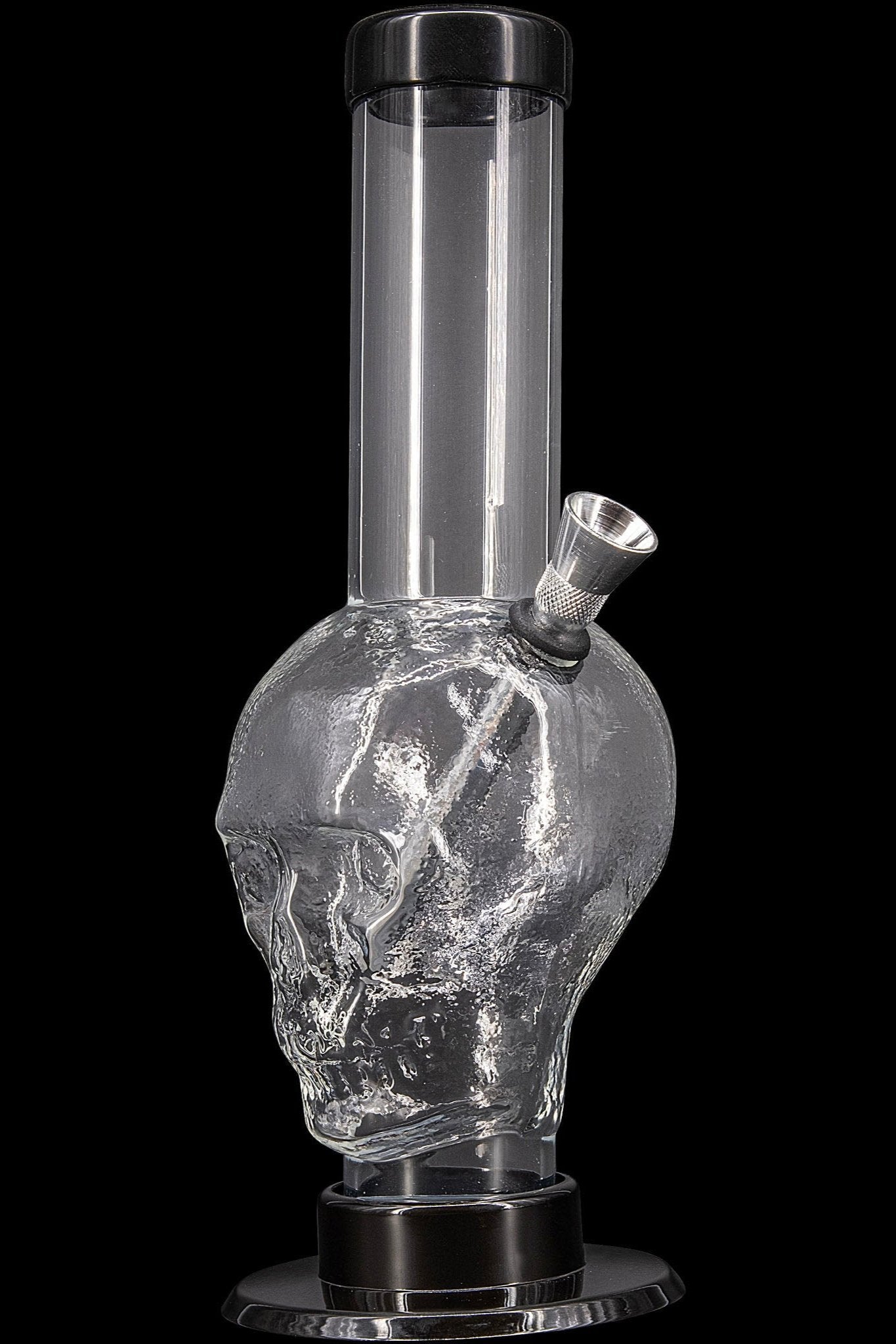 Glass water pipe shaped like a skull, filled with water.