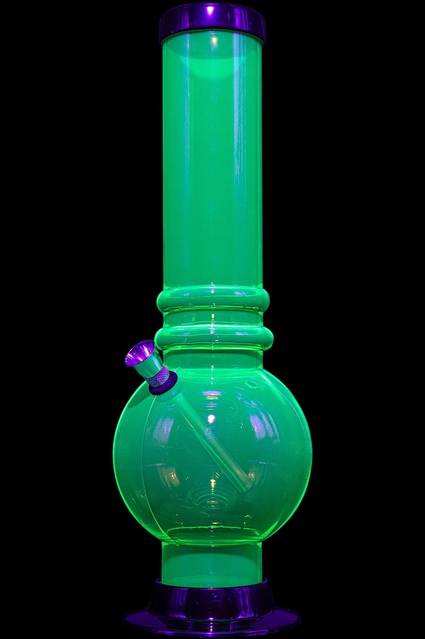 Green glass bong illuminated with UV light.