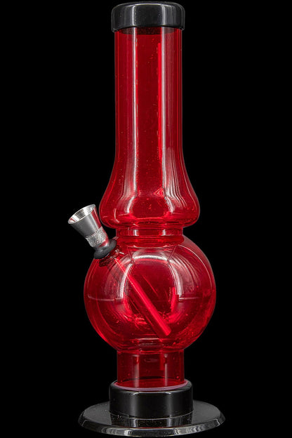 Red glass bubbler water pipe for smoking cannabis.