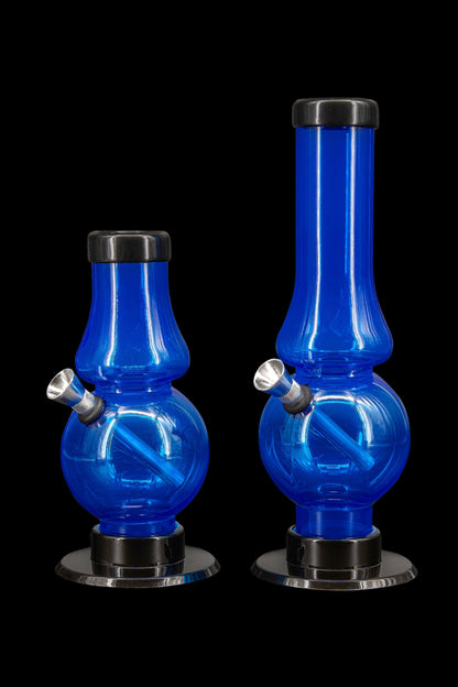 Two blue acrylic bubblers with black bases and mouthpieces, studio shot on a black background.