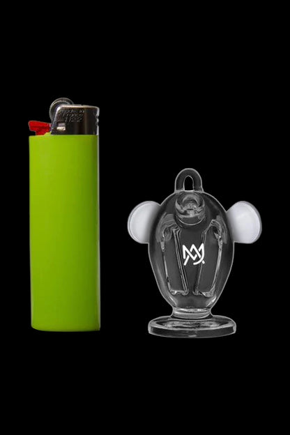 Green lighter next to a clear glass Mickey Mouse-shaped oil rig.