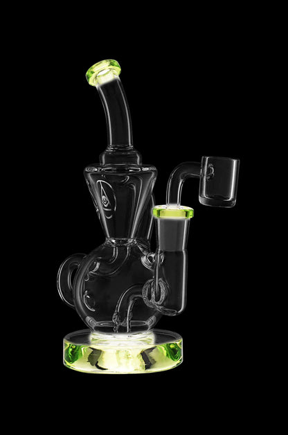 A clear glass dab rig with green accents, featuring a bubbler design and accompanying nail, isolated on a black background."