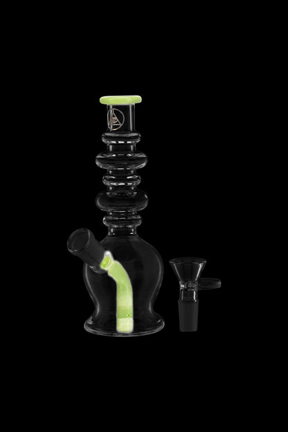 Glowing glass water pipe with a detached glass bowl.
