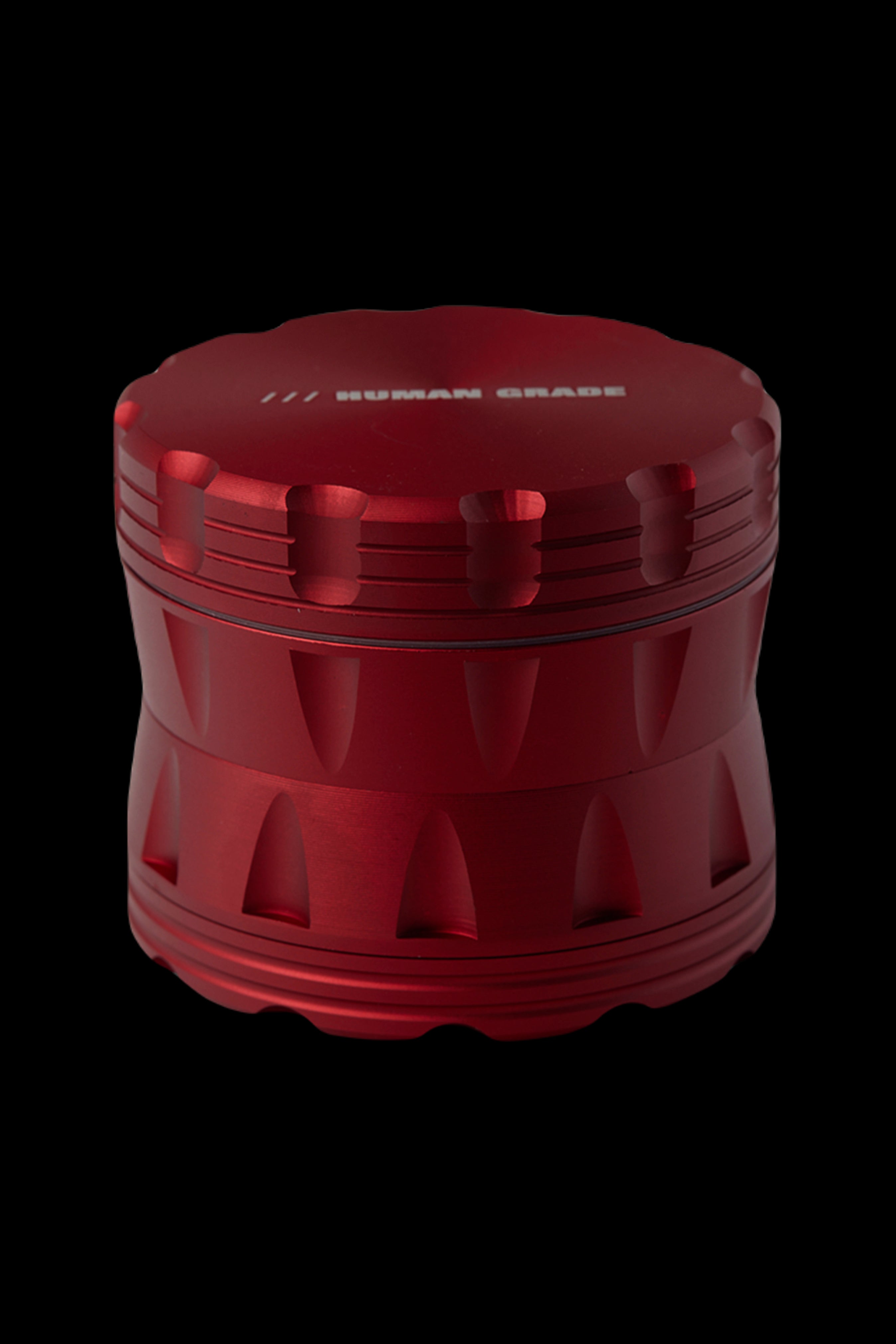 Red cannabis grinder with "HUMAN GRADE" etched on top.