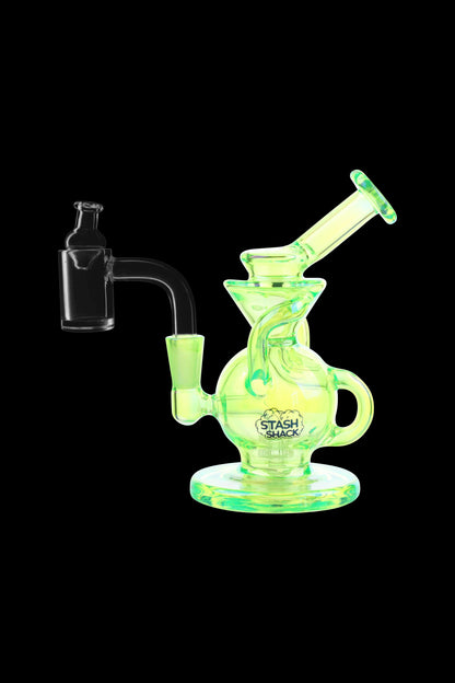 Glowing green glass dab rig with a quartz banger, branded “Stash Shack.”