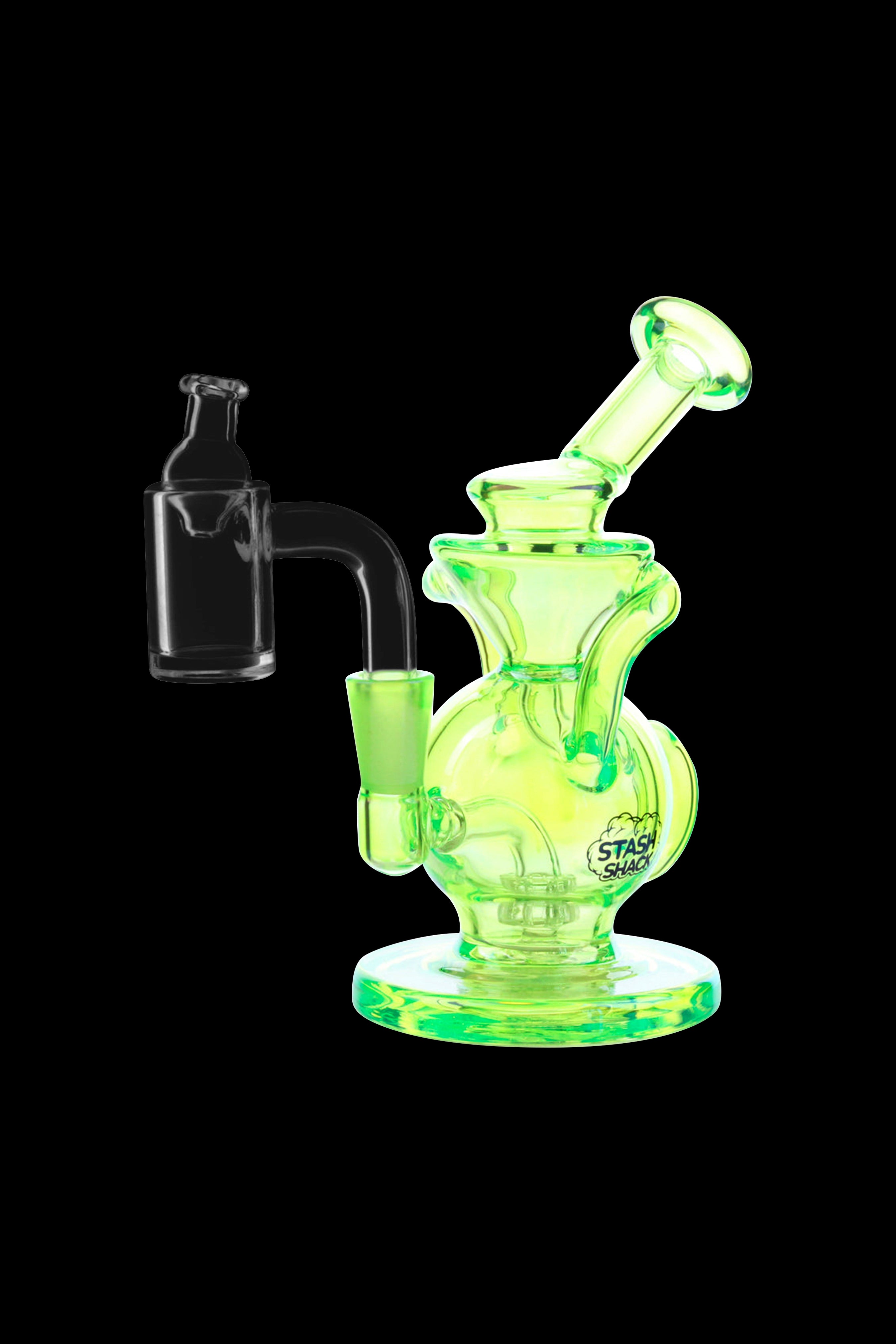 A glowing yellow glass dab rig with a quartz banger, positioned on a dark background.
