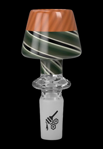 A glass cannabis bowl with a swirled green and amber design.
