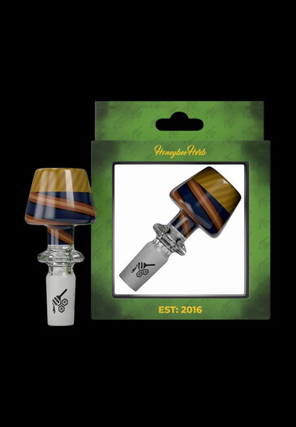 A packaged glass cannabis oil burner pipe with a colorful, layered design, branded "Honeybee Herb" and established in 2016.